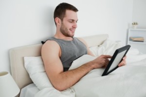 man-watching-tablet-in-bed1-460x306